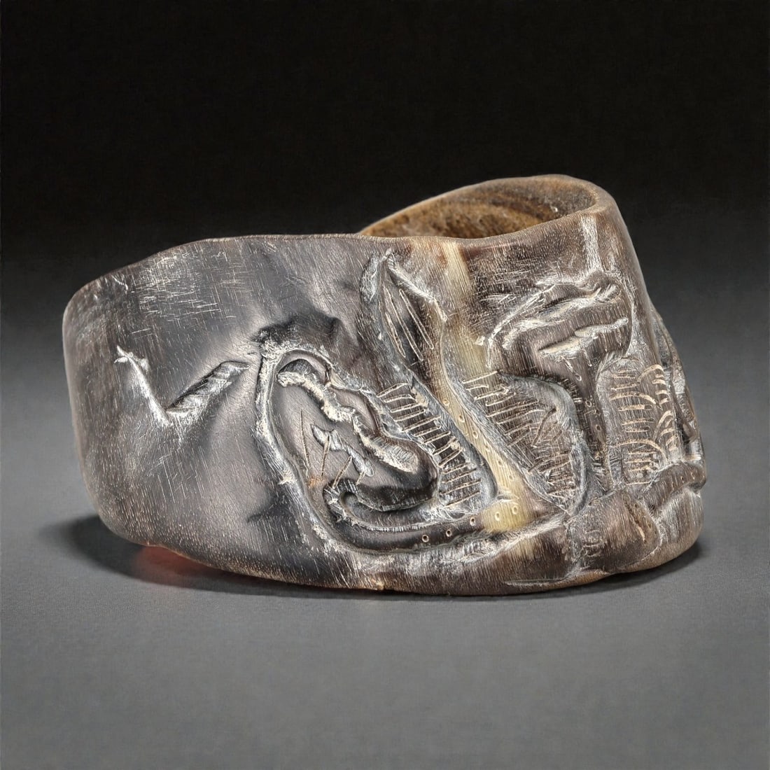 A Chinese Horseshoe Hoof (Ma Ti) Carved Brush Washer, 20th Century, 18YB: Carved from a natural horseshoe hoof (ma ti), the object is worked into a shallow, irregularly oval vessel with thick walls and an uneven rim, following the original organic form of the material. The