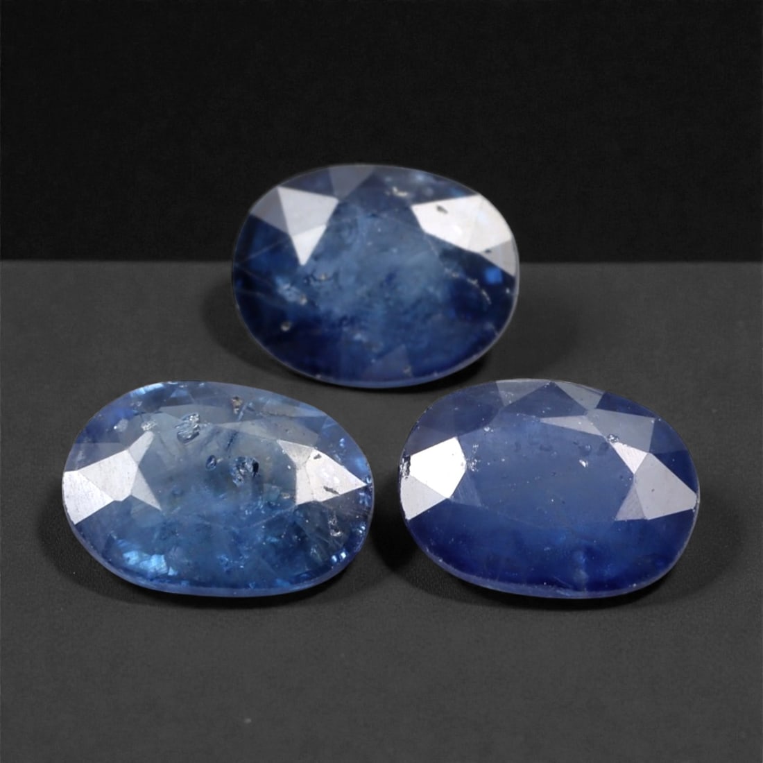 3.02 Carats Deep Blue Sapphire Parcel - Beryllium-Treated Burmese Stones, 332A: This rich parcel of three loose sapphire gems captivates with a deep, saturated blue hue that evokes the intensity of a midnight ocean and the depth of a clear night sky. Each stone is cut in a well-p