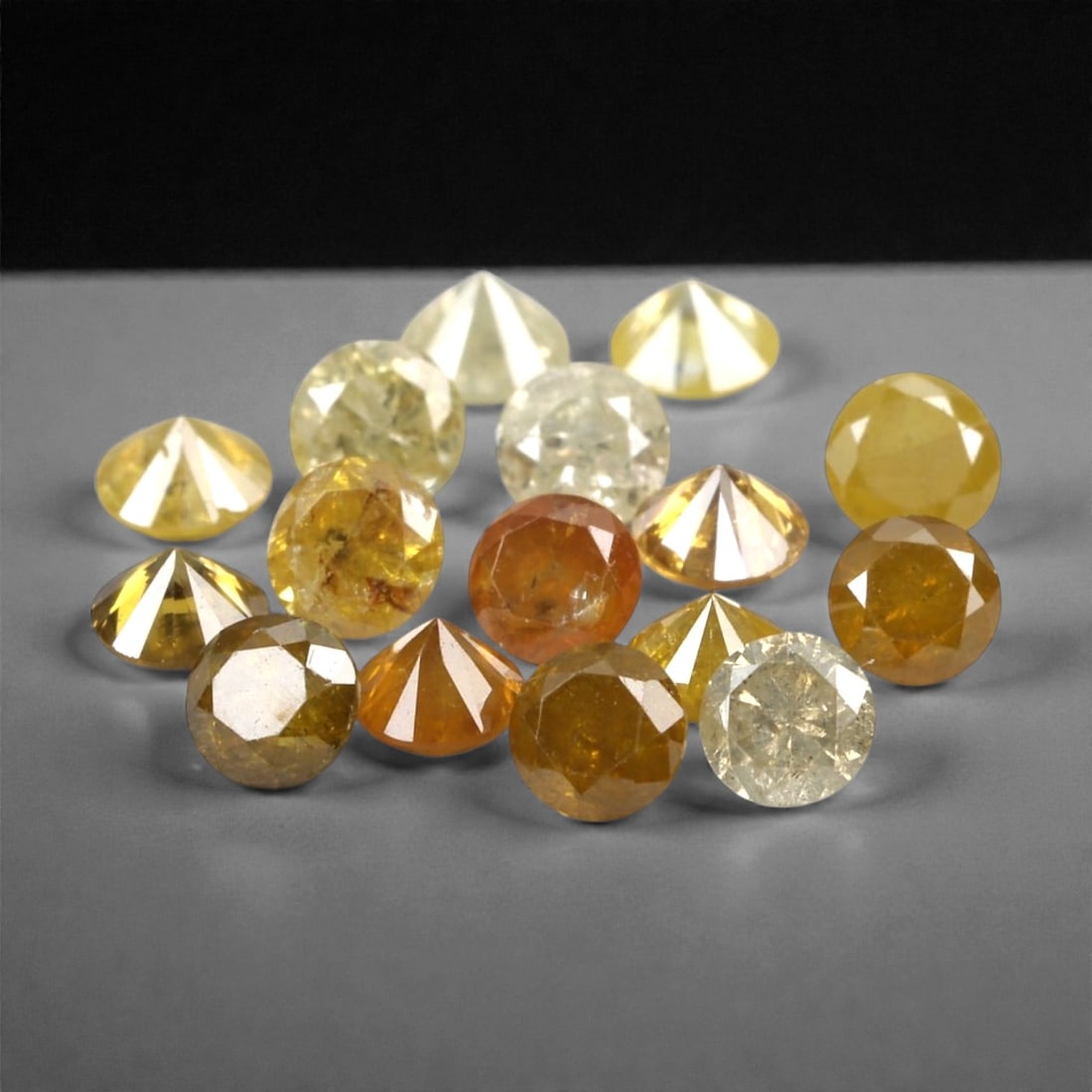 1.03 Carats Fancy Yellow Diamond Parcel - Natural African Stones, 52A: This exquisite parcel of round fancy diamonds radiates with a warm, honeyed glow, ranging from soft lemon and buttercup hues to deeper golden amber tones. Each stone is precision-cut to maximize light