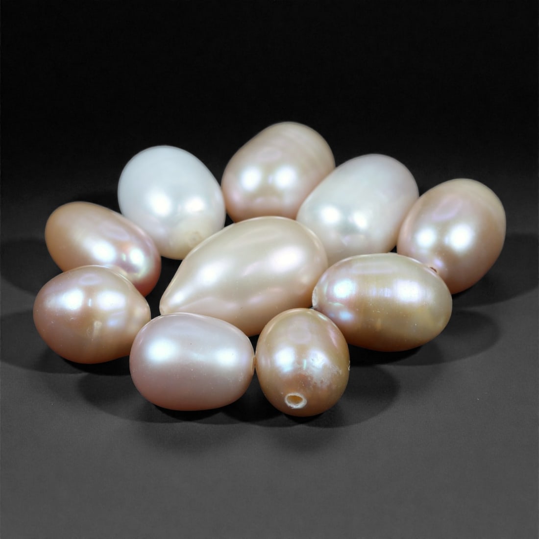30.54 Carats Natural Cultured Freshwater Pearl Lot - Oval to Drop Shapes - 6 to 11mm, 16XA: This luminous lot of cultured freshwater pearls presents a soft, elegant palette of champagne, blush, ivory, and rose tones. Each pearl is well-formed with smooth surfaces and attractive luster, rangi