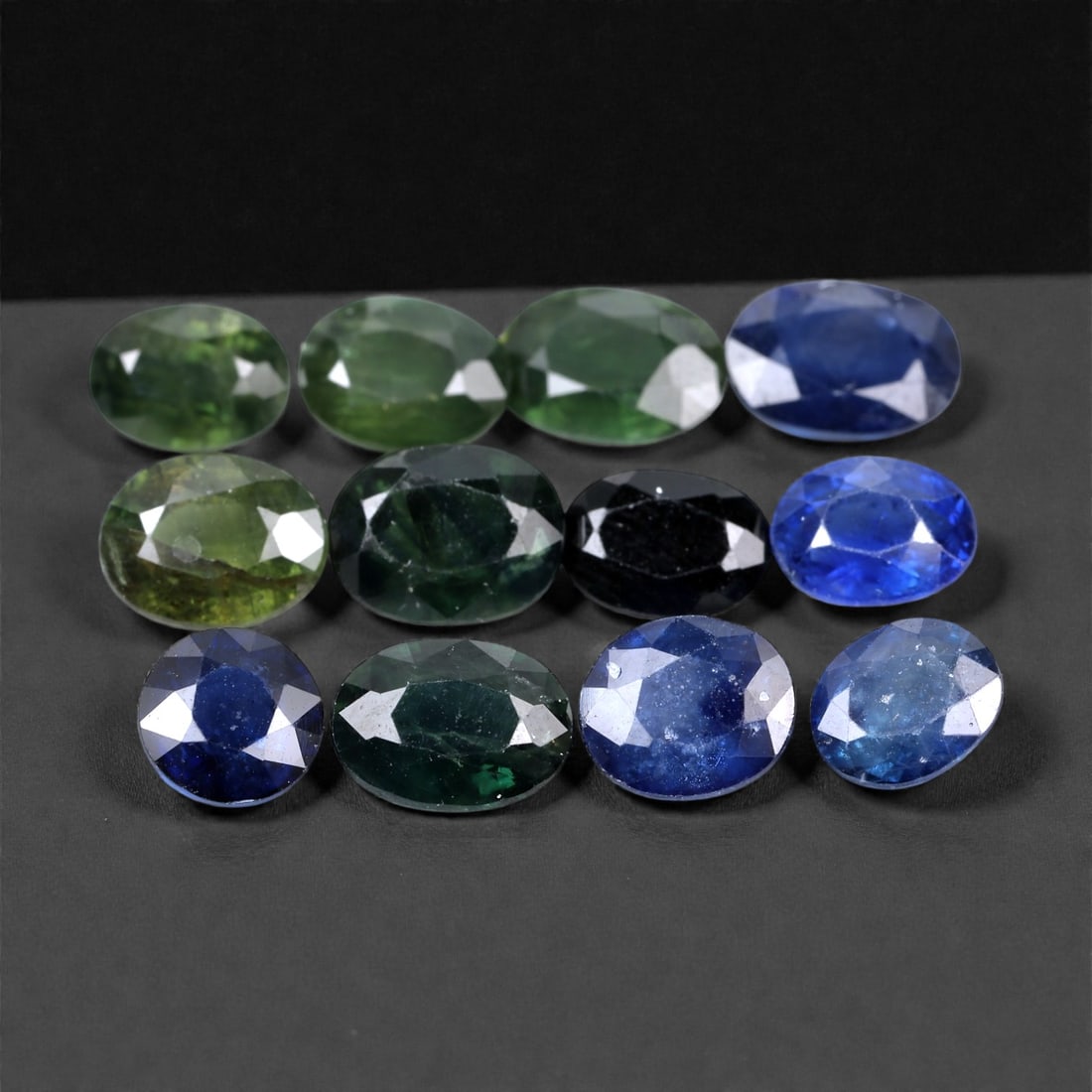 15.94 Carats Deep Green and Blue Sapphire Parcel - Natural Sri Lankan Stones 6-7mm, 75XH: This moody and elegant sapphire parcel features a distinctive blend of deep forest greens, midnight blues, and classic royal blue tones. Each stone reveals subtle variations in hue and internal textur