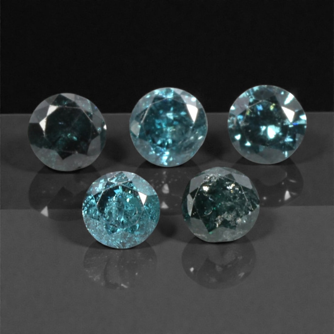 5 Pieces Irradiated Blue Diamond Parcel - Round Brilliant Cut, 2.4mm, 247A: This striking parcel of five loose irradiated blue diamond gems captivates with a vivid, cool blue hue that evokes the intensity of a deep ocean and the clarity of a winter sky. Each stone is cut in a