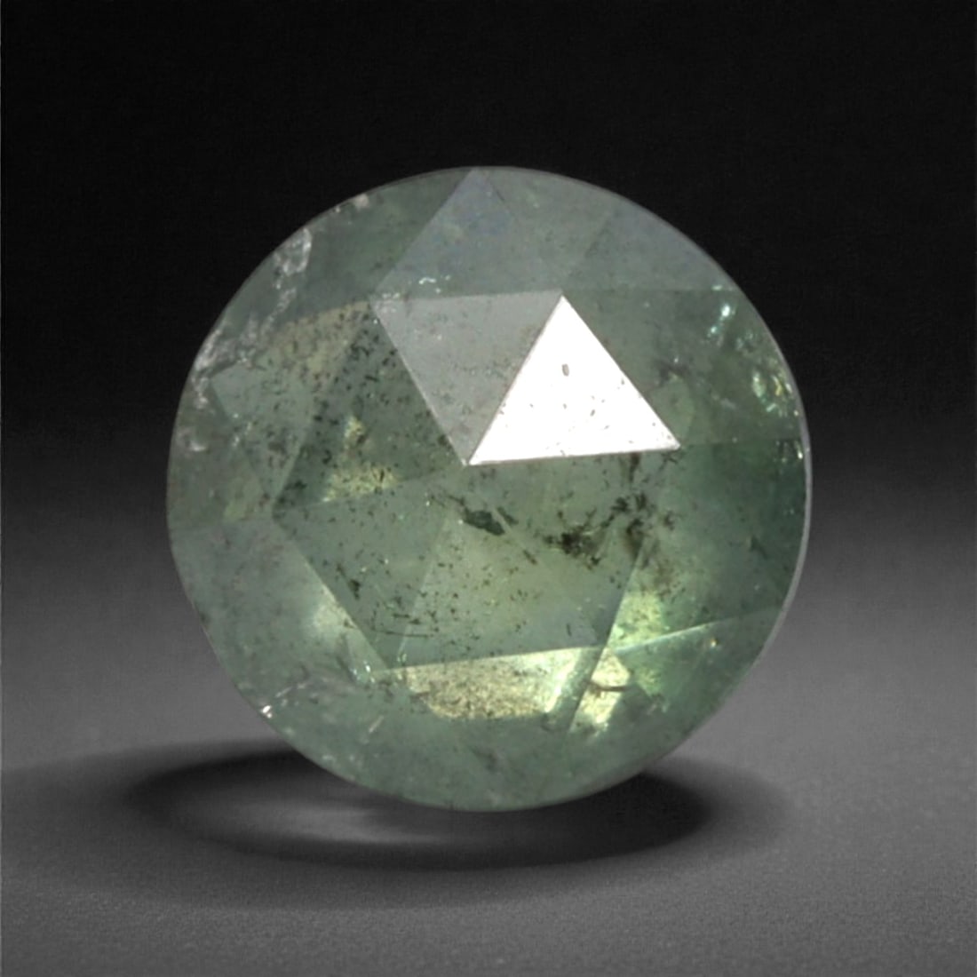 0.24 Carats Fancy Green Rose Cut Diamond - Natural Loose Gemstone, 46DA: This 0.24 carat rose cut diamond captivates with a soft, muted fancy green hue that radiates gentle, earthy warmth from its distinctive flat, faceted surface. The classic rose cut, with its symmetrica