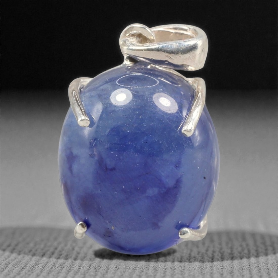 14.60 Carats Deep Blue Sapphire Cabochon Pendant - Sterling Silver Setting, 159A: This striking pendant features a substantial deep blue sapphire cabochon, set in a polished sterling silver frame stamped 925. The cabochon's smooth, domed surface radiates with a rich, velvety blue h