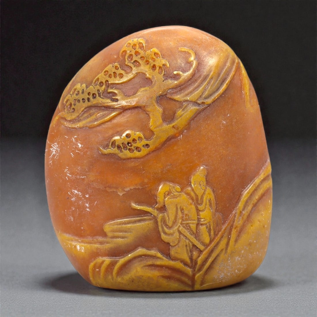A Chinese Shoushan Stone Stamp Seal, 20th Century, 7FA: Carved from Shoushan stone with warm ochre, honey, and russet tones displaying natural color banding, the seal is of rectangular form with a slightly rounded top. One side is carved in low relief with