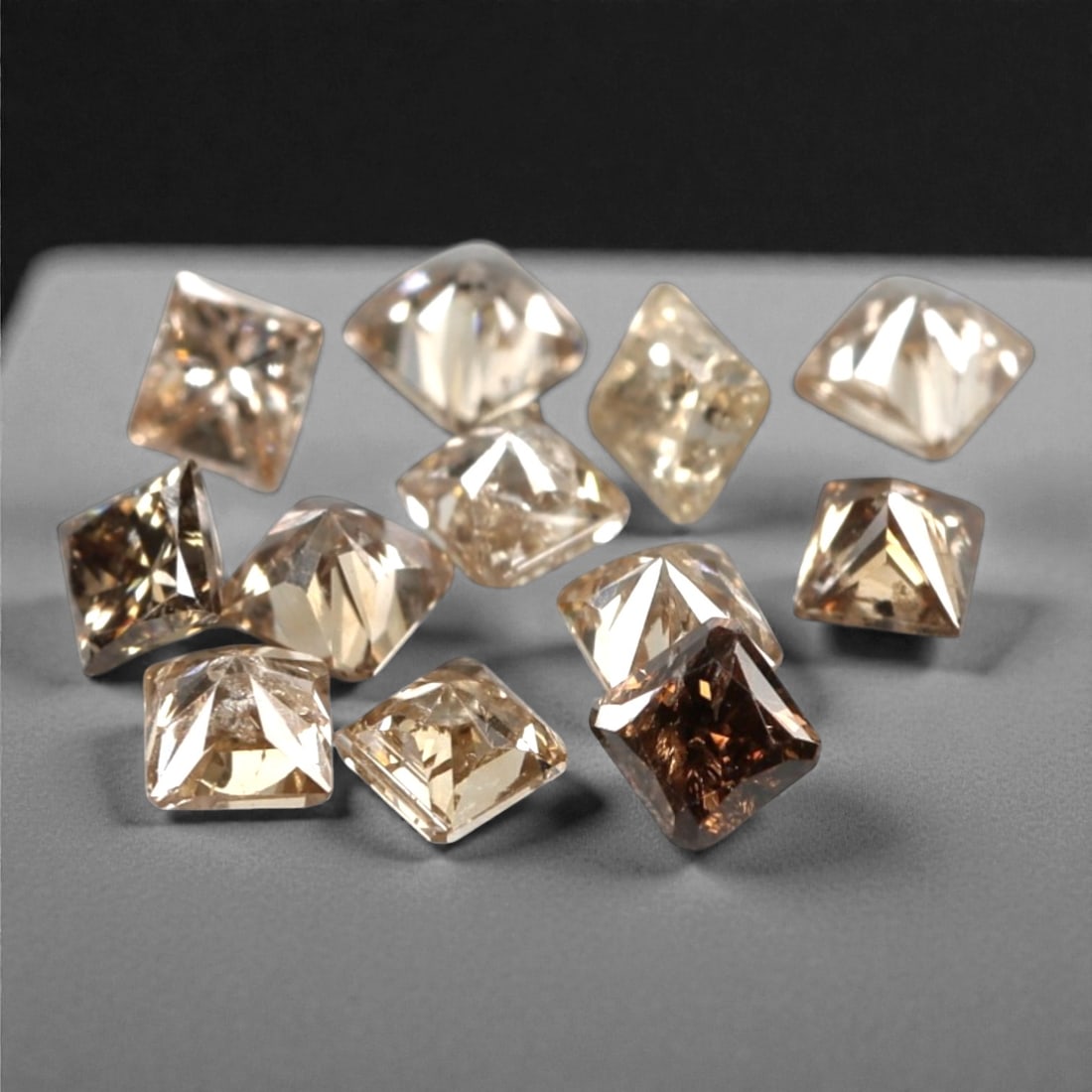 0.52ct 12 Pieces Champagne Diamond Parcel - Princess Cut, 219A: This elegant parcel of 12 loose champagne diamond gems captivates with a warm, honeyed hue that evokes the richness of aged champagne and the glow of liquid sunlight. Each stone is cut in a well-propo