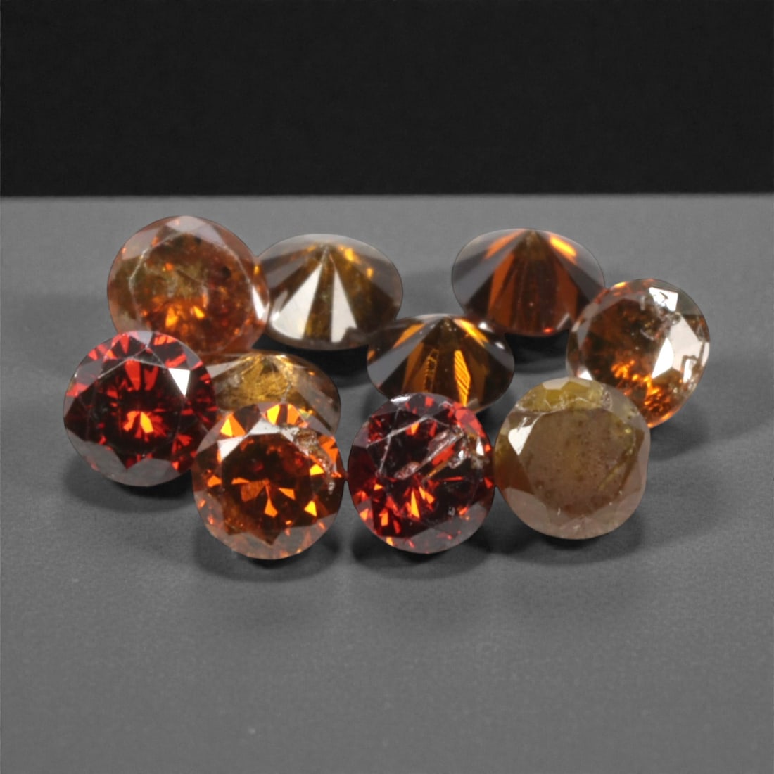 10 Pieces Irradiated Red Diamond Parcel - Round Brilliant Cut, 1.6-1.7mm, 263A: This vibrant parcel of 10 loose irradiated red diamond gems captivates with a rich, fiery red hue that evokes the intensity of a glowing ember and the warmth of a sunset. Each stone is cut in a well-p