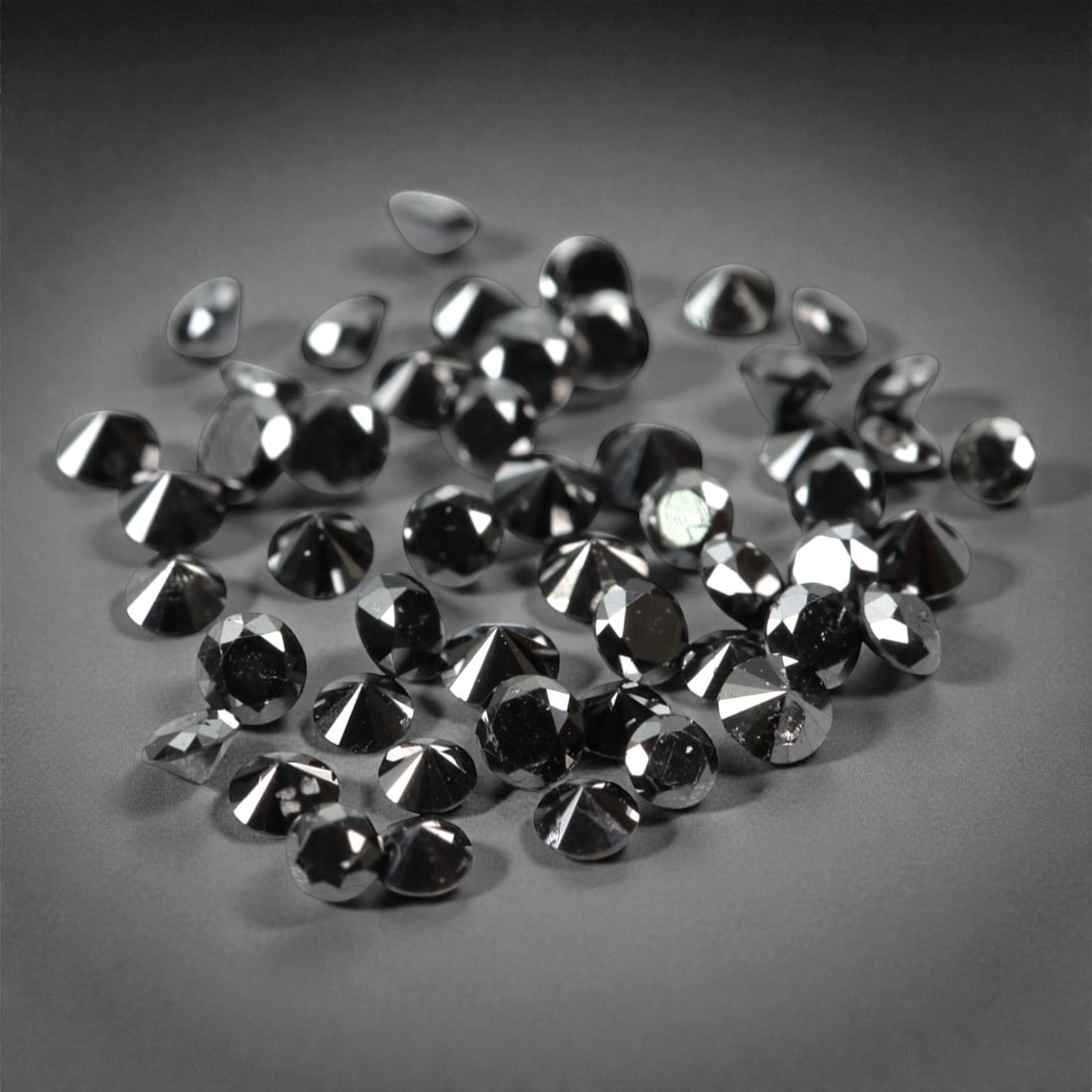 50 Pieces Black Diamond Parcel - Round Brilliant Cut, 1.7mm, 175A: This versatile parcel of 50 loose black diamond gems captivates with a deep, opaque black hue that evokes the intensity of polished obsidian and the mystery of a midnight sky. Each stone is cut in a w