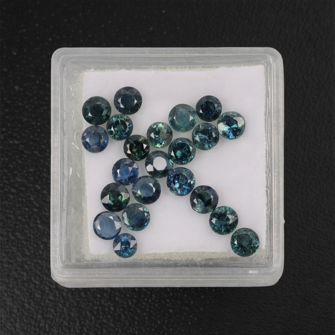 4.58 Carats Multitone Parti Sapphire Parcel - Natural Australian Stones, 21XL: This vibrant parcel of parti sapphires showcases a rich spectrum of deep teal, forest green, and moody blue tones, each round, faceted stone exhibiting dynamic color zoning that shifts and glows under