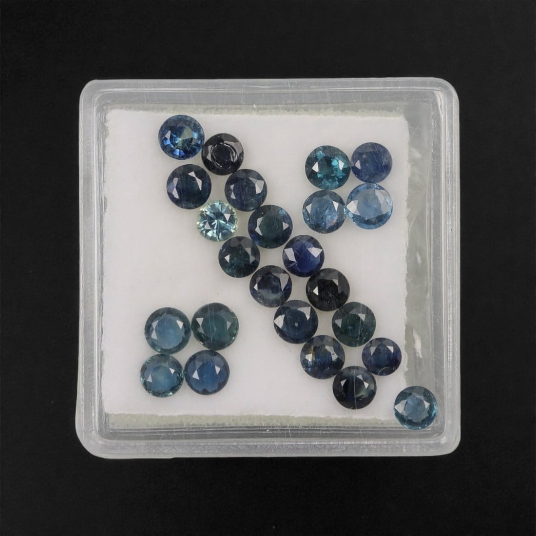 3.87 Carats Multitone Parti Sapphire Parcel - Natural Australian Stones, 26XL: This curated parcel of parti sapphires presents a striking blend of deep teal, forest green, and vivid blue tones, with dynamic color zoning that shifts and glows under changing light. Each round, fac