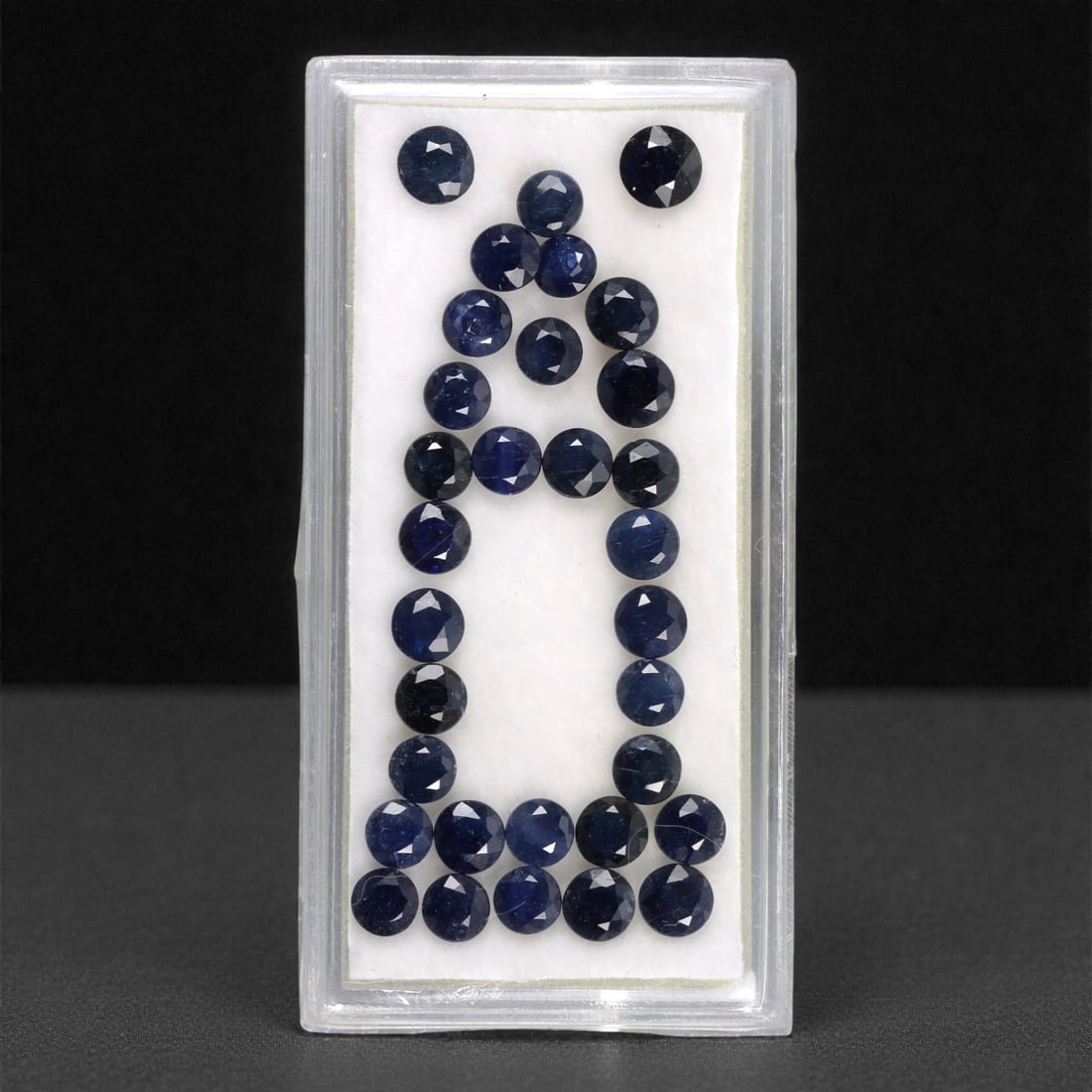 8.10 Carats Australian Blue Sapphire Parcel - Round Brilliant Cut, 70DA: This curated parcel of round brilliant-cut blue sapphires from Australia exhibits a rich, deep blue hue, reminiscent of the ocean at midnight. Each stone is precision-cut to maximize light return, cre