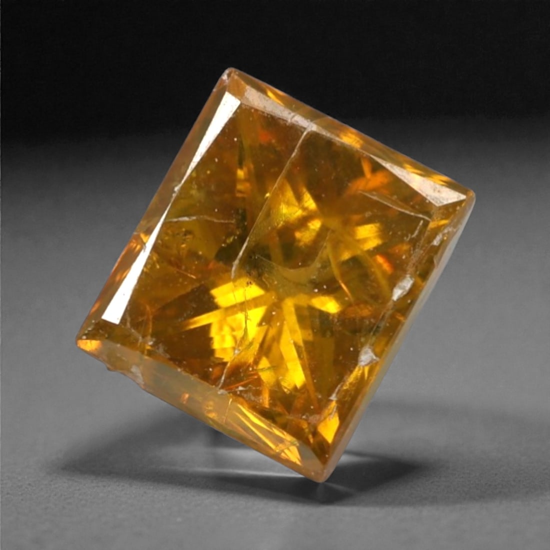 0.36 Carats Orangy Red Fancy Diamond - Princess Cut, 191A: This rare fancy orangy red diamond captivates with a vivid, warm hue that evokes the intensity of a glowing ember and the richness of a sunset. Cut in a well-proportioned princess shape, the stone's f