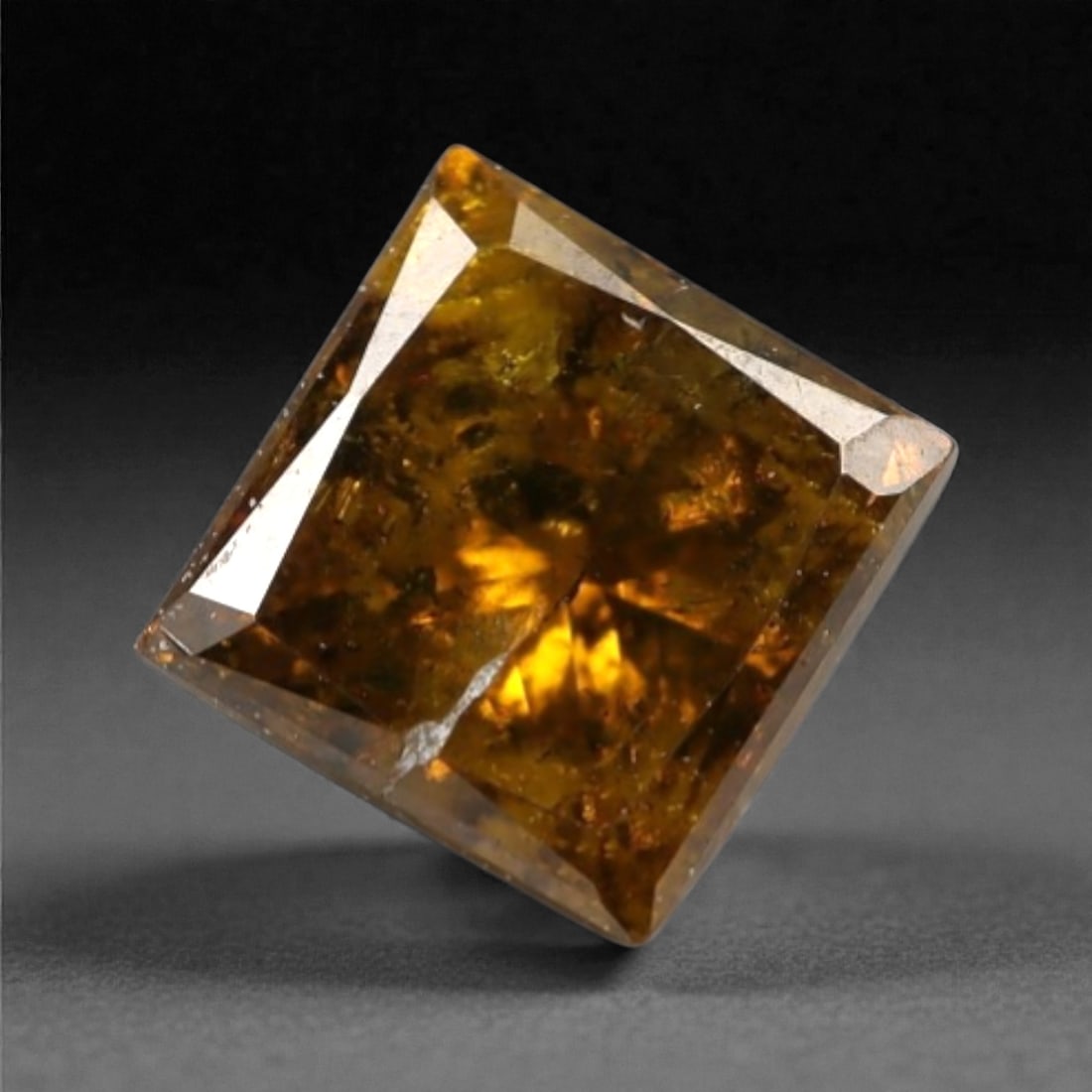0.30 Carats Orangy Red Fancy Diamond - Princess Cut, 198A: This rare fancy orangy red diamond captivates with a vivid, warm hue that evokes the intensity of a glowing ember and the richness of a sunset. Cut in a well-proportioned princess shape, the stone's f