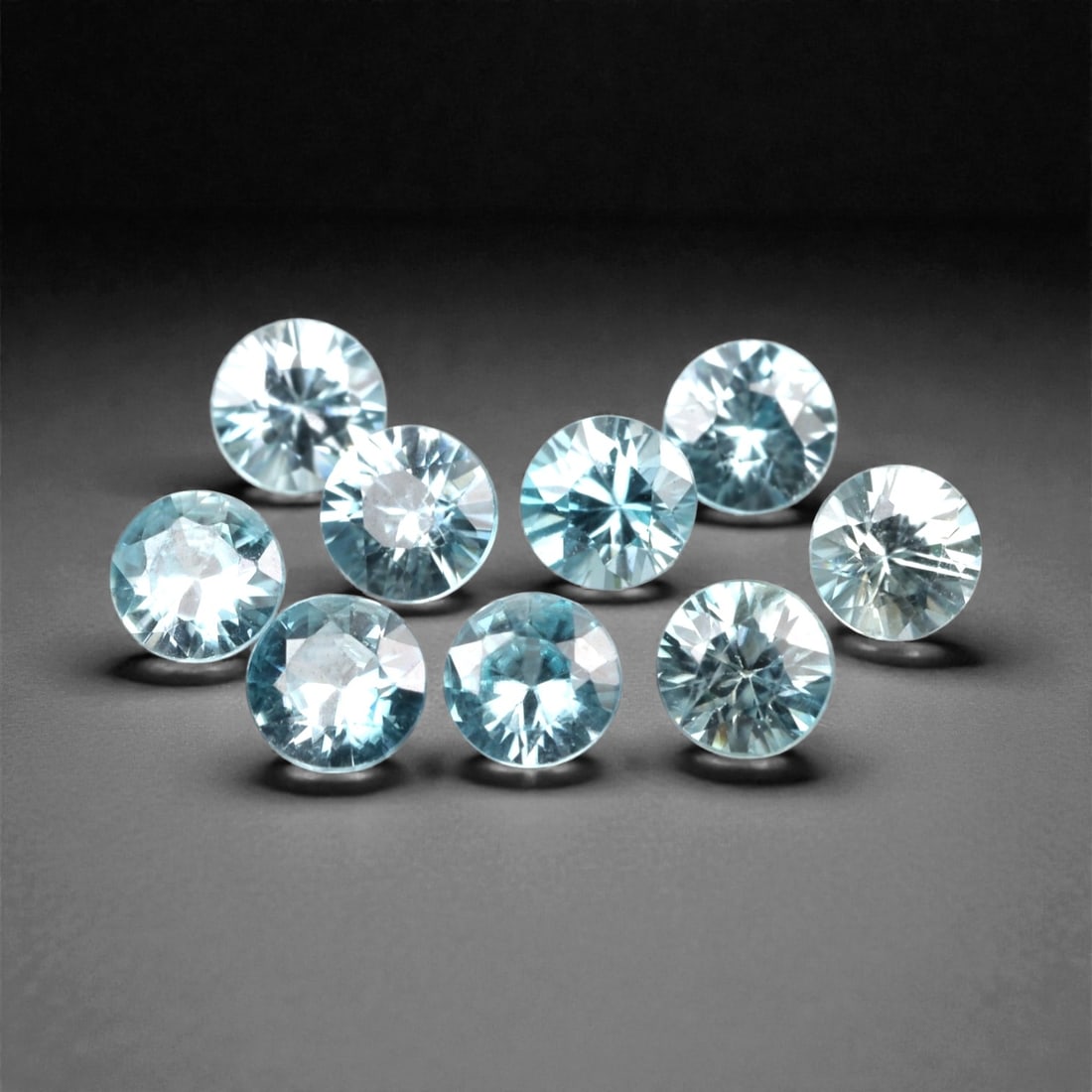 3.30 Carats Sky Blue Zircon Selection - Natural Cambodian Stones, 378A: This curated selection of nine round-cut zircon gems presents a serene, sky-blue hue, reminiscent of clear tropical waters and open summer skies. Each stone is precision-faceted to maximize light disp
