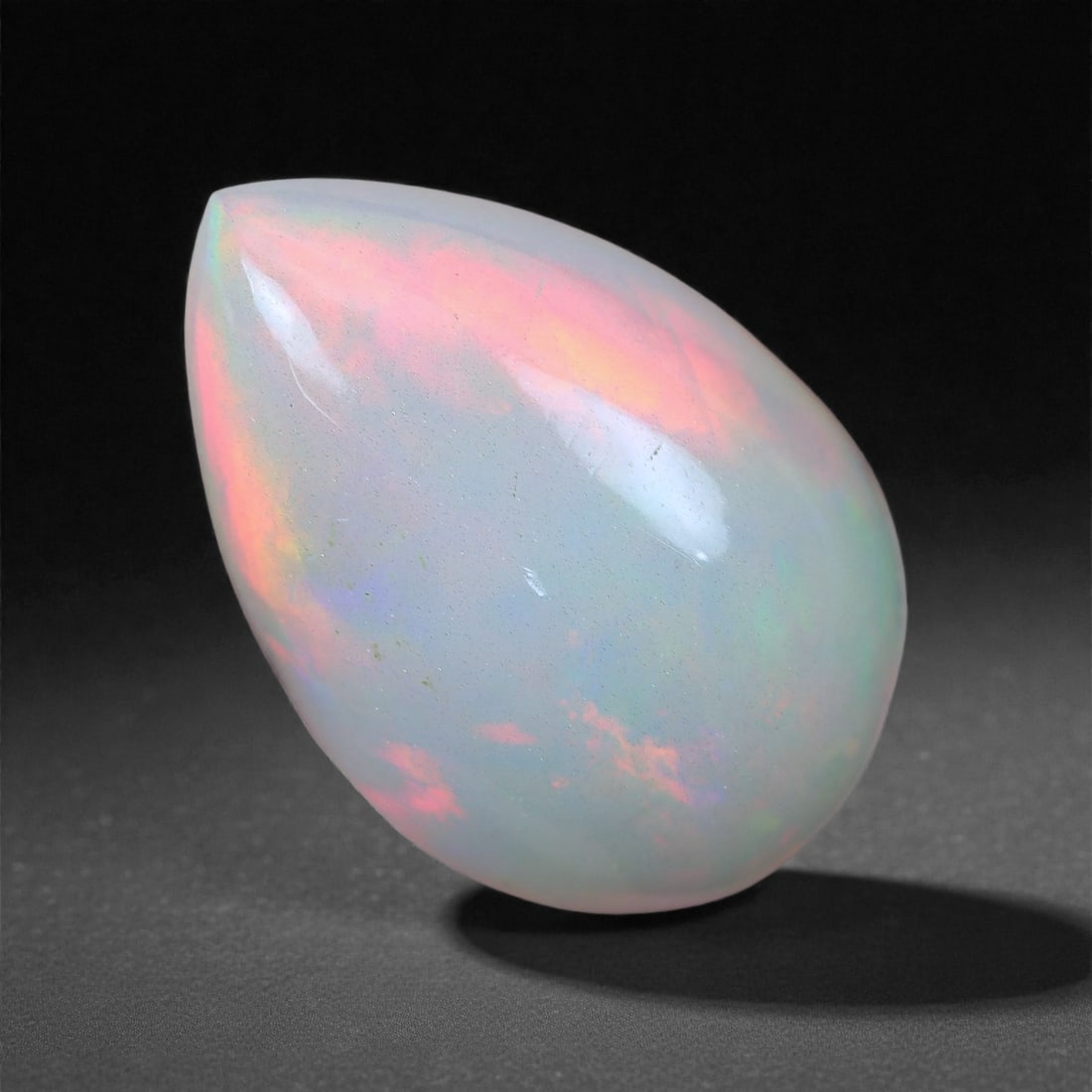 3.96 Carats Pastel Fire Welo Opal - Natural Ethiopian Gemstone 11.9x9.2x7.1mm, 39XH: This ethereal Welo opal glows with a soft pastel play-of-color, where delicate flashes of coral pink, mint green, and sky blue emerge through a translucent body. Its serene palette evokes the look of