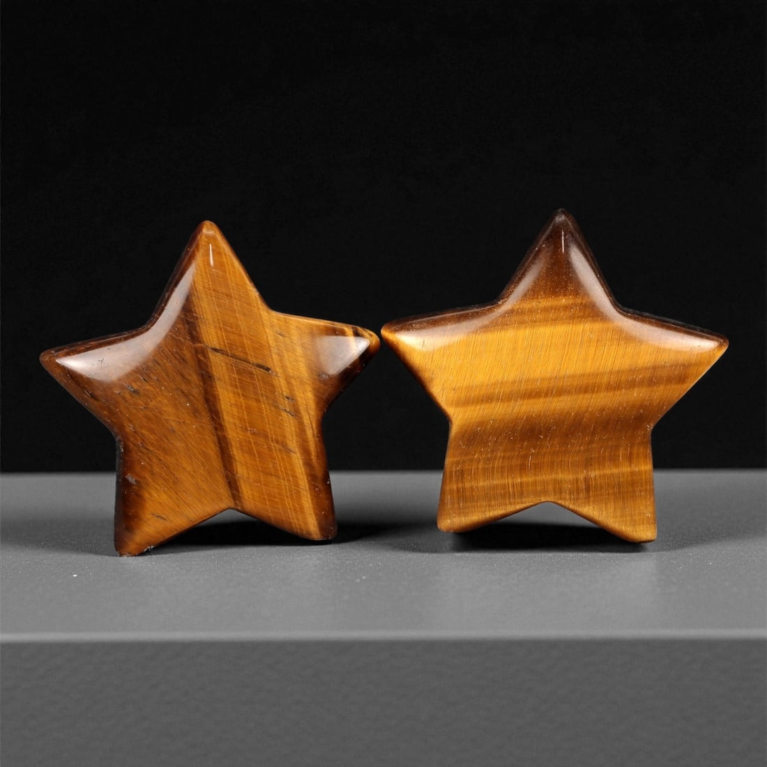 78 Carats Golden Tiger's Eye Star Pair - Natural South African Carvings, 37XC: This charming pair of hand-carved tiger's eye stars gleams with warm golden-brown tones and strong chatoyancy. Each star flashes with silky light movement across its polished surface, revealing rich b