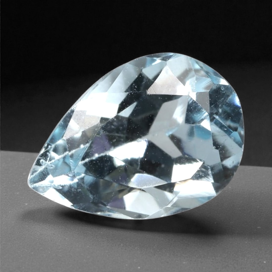 3.03 Carats Sky Blue Topaz - Natural Brazilian Stone, 307A: This exceptional pear-cut topaz gemstone captivates with a serene, sky-blue hue, reminiscent of clear tropical waters and open summer skies. The precision faceting maximizes light dispersion, creating