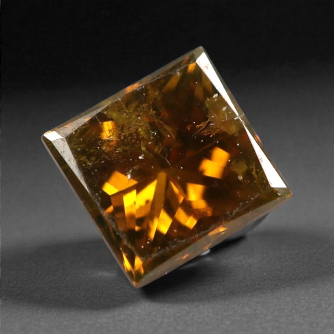 0.25 Carats Orangy Red Fancy Diamond - Princess Cut, 197A: This rare fancy orangy red diamond captivates with a vivid, warm hue that evokes the intensity of a glowing ember and the richness of a sunset. Cut in a well-proportioned princess shape, the stone's f
