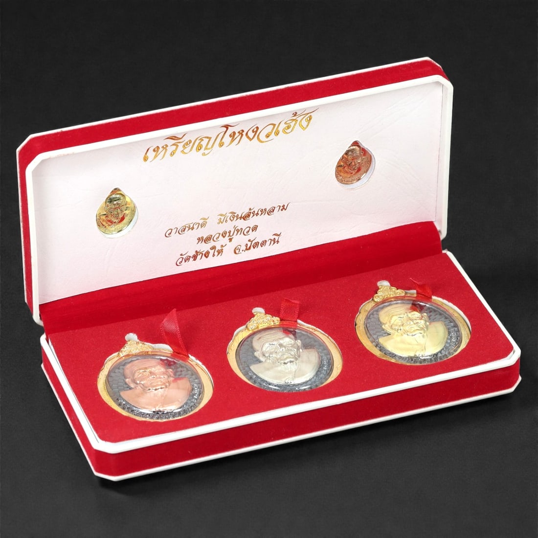 A Thai Gilt and Bronze Monk Medallion Set, Late 20th-Early 21st Century, 52FJ: The set comprises three circular portrait medallions cast in bronze and finished with gilt and contrasting metal tones, each depicting a Buddhist monk in high relief bust format. The monk is shown wit