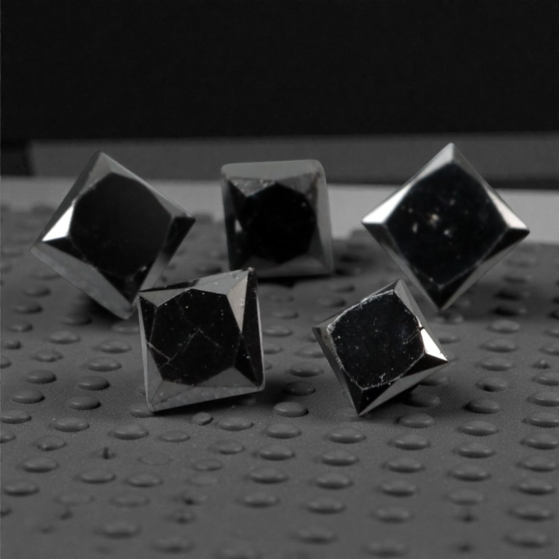 0.80 Carats Black Diamond Parcel - Princess Cut, 239A: This striking parcel of five loose black diamond gems captivates with a deep, opaque black hue that evokes the intensity of polished obsidian and the mystery of a midnight sky. Each stone is cut in a