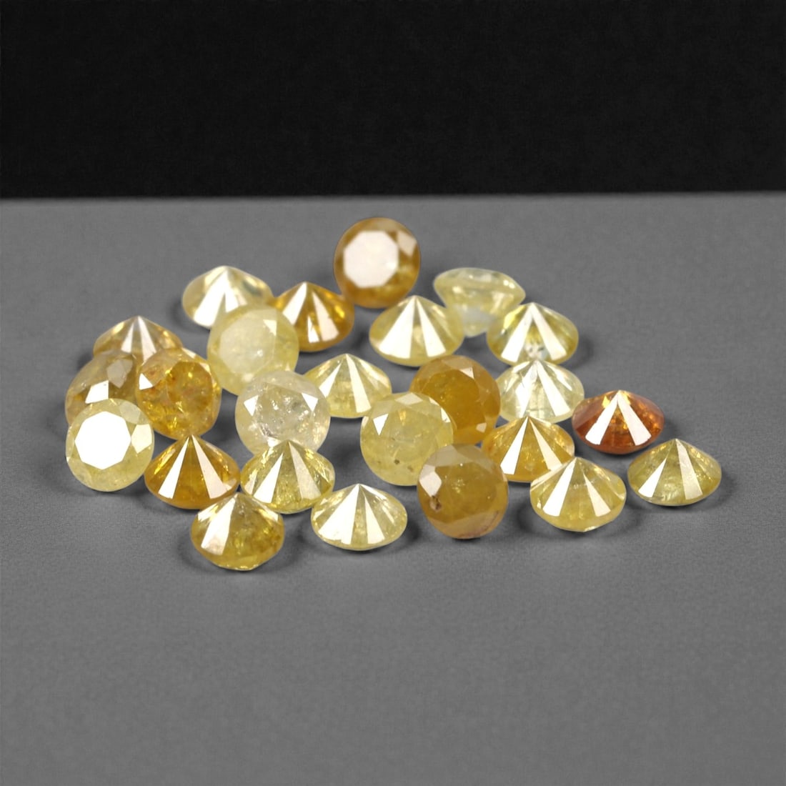 1.16 Carats Fancy Yellow Diamond Parcel - Natural African Stones, 50A: This exquisite parcel of round fancy diamonds radiates with a warm, honeyed glow, ranging from soft lemon and buttercup hues to deeper golden amber tones. Each stone is precision-cut to maximize light