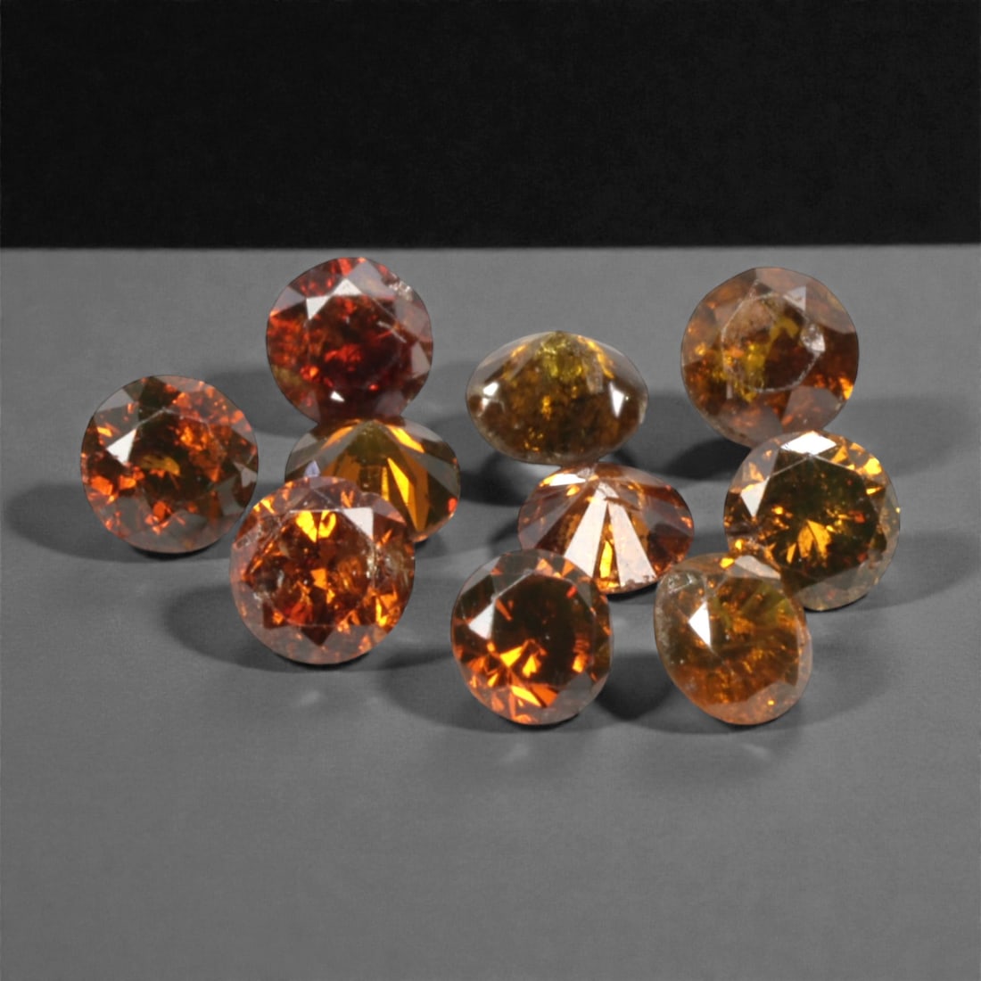 10 Pieces Irradiated Red Diamond Parcel - Round Brilliant Cut, 1.6-1.7mm, 273A: This vibrant parcel of 10 loose irradiated red diamond gems captivates with a rich, fiery red hue that evokes the intensity of a glowing ember and the warmth of a sunset. Each stone is cut in a well-p