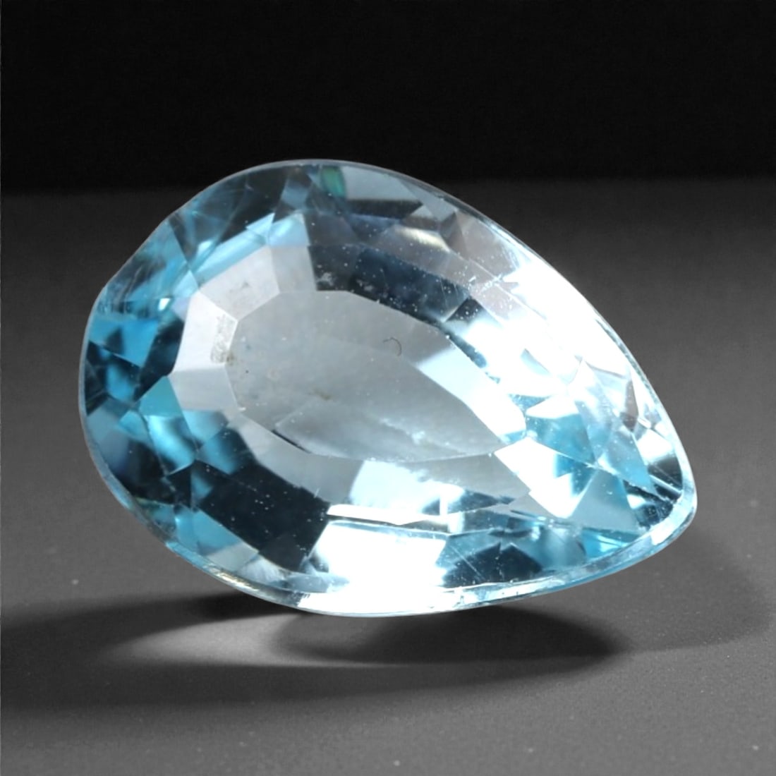 3.49 Carats Sky Blue Topaz - Natural Brazilian Stone, 385A: This exceptional pear-cut topaz gemstone captivates with a serene, sky-blue hue, reminiscent of clear tropical waters and open summer skies. The precision faceting maximizes light dispersion, creating