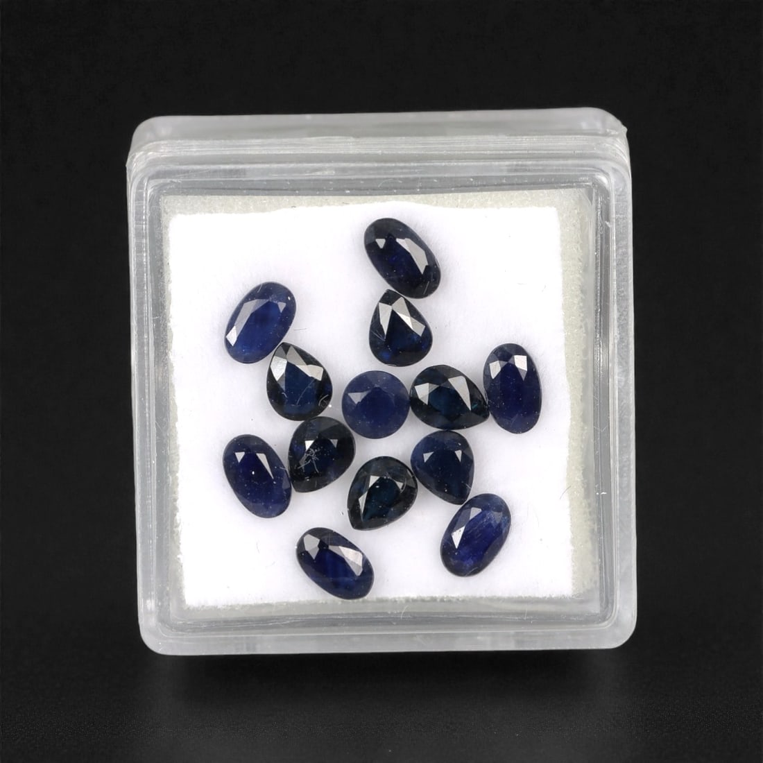 4.34 Carats Australian Blue Sapphire Parcel - Mixed Cut, 91DA: This curated parcel of mixed-cut blue sapphires from Australia exhibits a rich, deep blue hue, reminiscent of the ocean at midnight. The stones are precision-cut in a variety of shapes, including oval