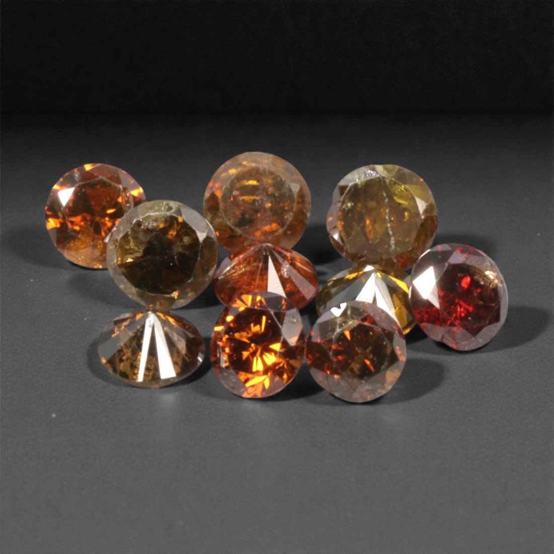10 Pieces Irradiated Red Diamond Parcel - Round Brilliant Cut, 1.6-1.7mm, 267A: This vibrant parcel of 10 loose irradiated red diamond gems captivates with a rich, fiery red hue that evokes the intensity of a glowing ember and the warmth of a sunset. Each stone is cut in a well-p