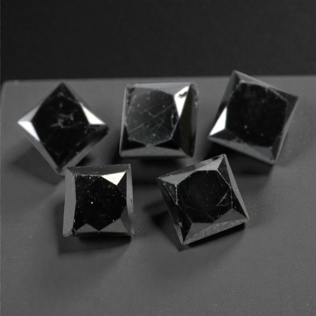 0.97 Carats Black Diamond Parcel - Princess Cut, 232A: This striking parcel of five loose black diamond gems captivates with a deep, opaque black hue that evokes the intensity of polished obsidian and the mystery of a midnight sky. Each stone is cut in a