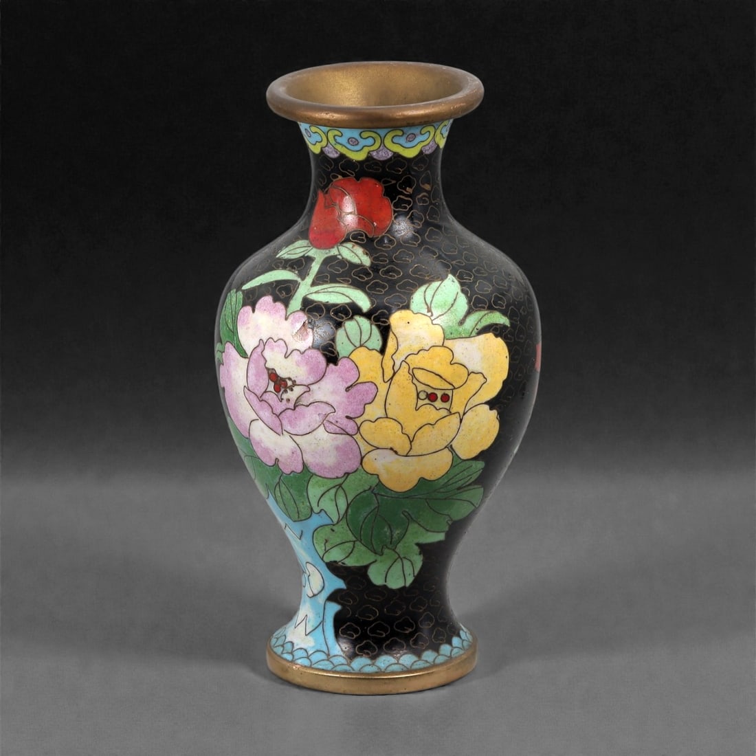 A Chinese Cloisonne Enamel Vase, 20th Century, 5FJ: The vessel is formed of a copper alloy body with applied cloisonne wirework and opaque enamel decoration. It is potted with a baluster-shaped body rising from a slightly spreading foot to a waisted ne