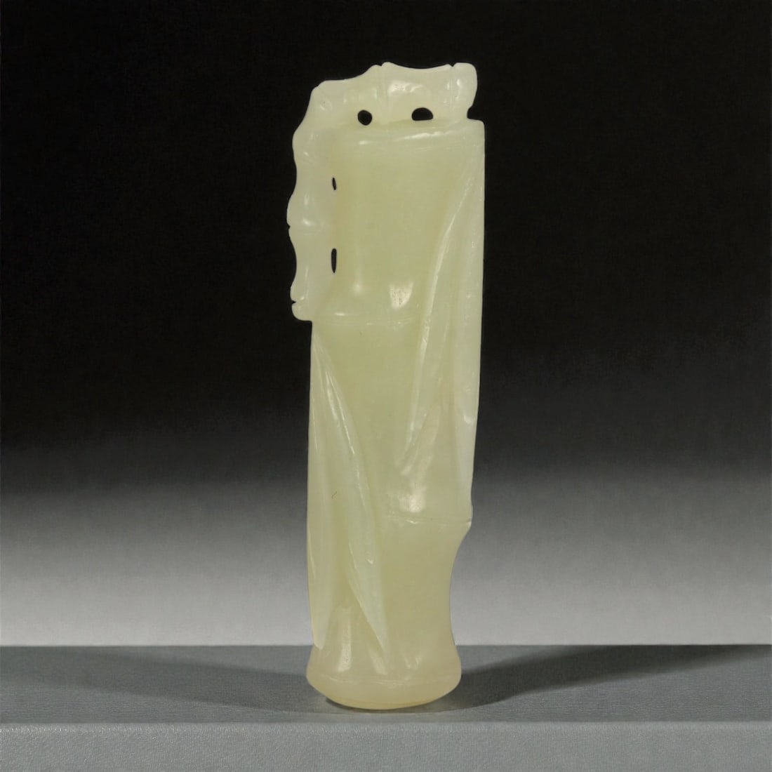 A Chinese Jade Bamboo Carving, 20th Century, 71FA: Carved from pale yellow jade with a soft, semi-translucent appearance and subtle tonal variation, the object is formed as a slender bamboo stalk rendered in the round. The surface is articulated with