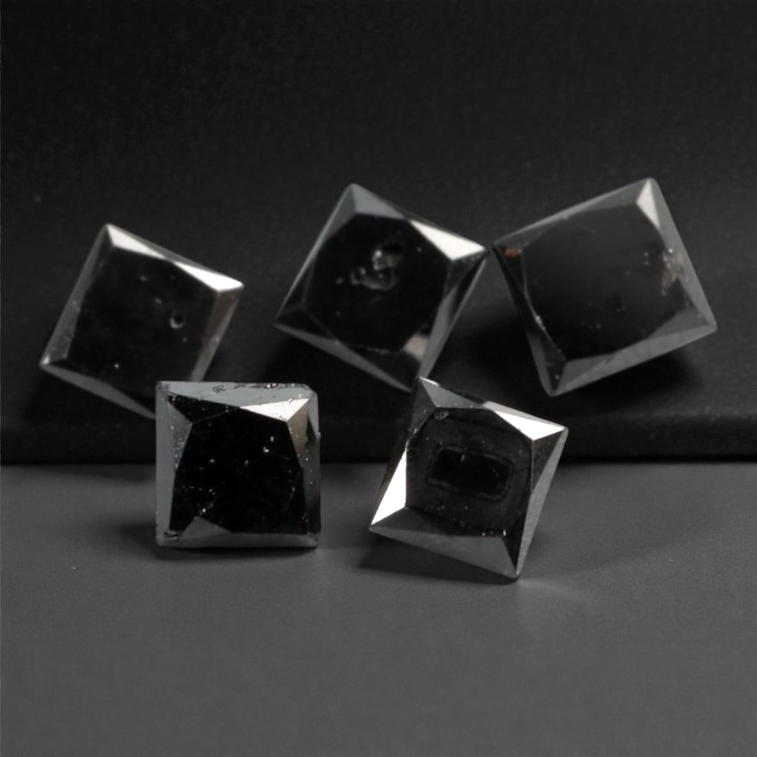 0.90 Carats Black Diamond Parcel - Princess Cut, 229A: This striking parcel of five loose black diamond gems captivates with a deep, opaque black hue that evokes the intensity of polished obsidian and the mystery of a midnight sky. Each stone is cut in a