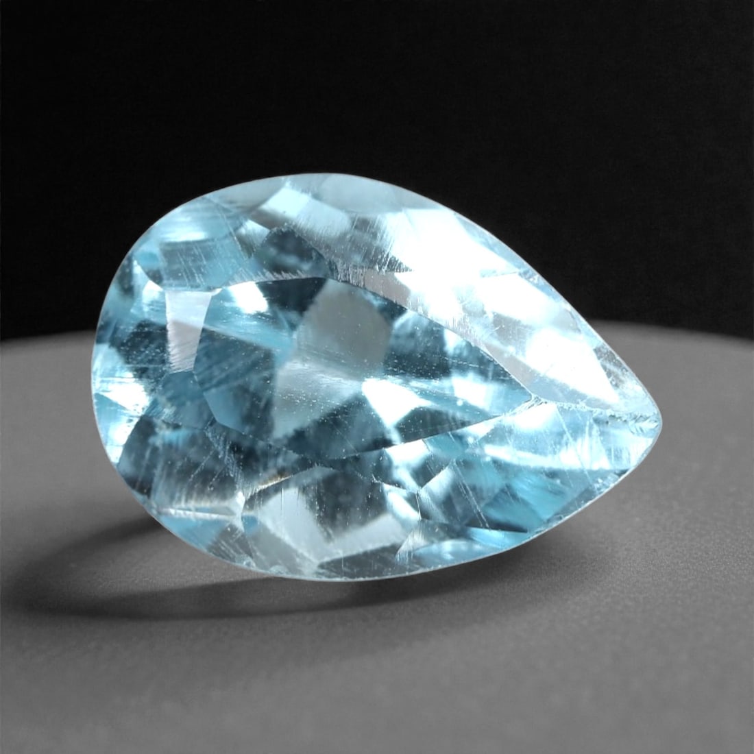 3.76 Carats Sky Blue Topaz Pear - Natural Brazilian Stone, 322A: This luminous sky blue topaz gem captivates with a soft, icy blue hue that evokes the clarity of a bright winter sky and the tranquility of glacial waters. Cut in a well-proportioned pear shape, the s