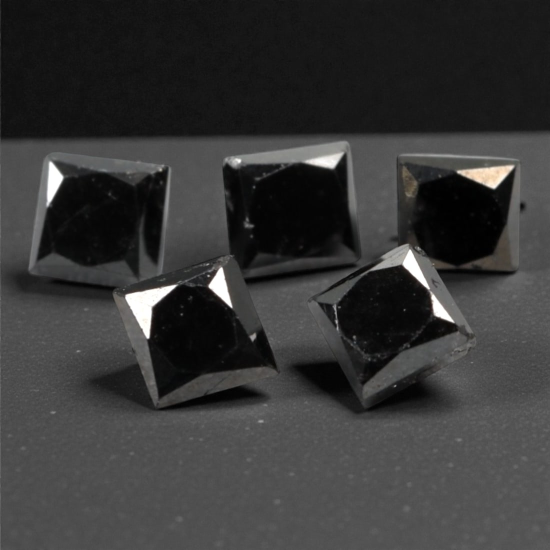 1.10 Carats Black Diamond Parcel - Princess Cut, 225A: This striking parcel of five loose black diamond gems captivates with a deep, opaque black hue that evokes the intensity of polished obsidian and the mystery of a midnight sky. Each stone is cut in a