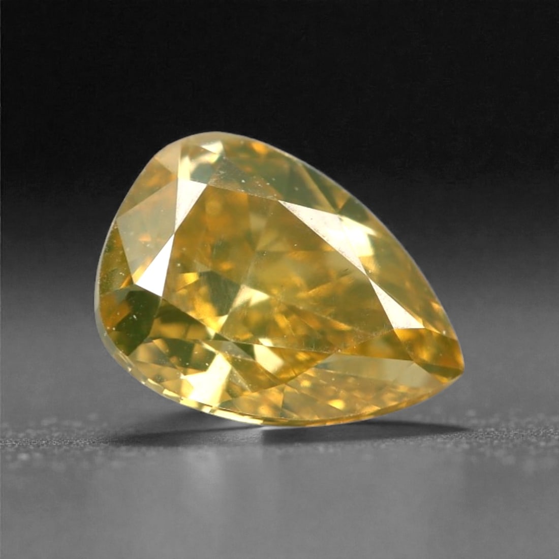 0.34 Carats Fancy Intense Yellow Diamond - Natural South African Origin, 2DA: This 0.34 carat fancy intense yellow diamond dazzles with a rich, saturated canary hue that radiates warmth and vibrancy from every precisely cut facet. The pear brilliant cut enhances the stone's nat