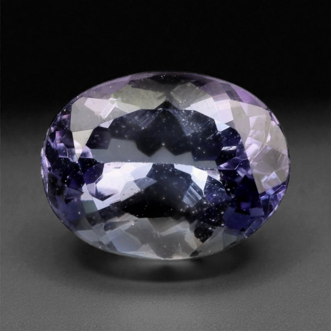 2.12 Carats Violet-Blue Tanzanite - Natural Tanzanian - 9.3 x 6.9 x 4.5 mm, 23WE: This richly hued tanzanite showcases a vivid interplay of violet and blue, cut in an elegant oval that reveals its inner brilliance with every shift of light. Flashes of indigo and lilac emerge from t