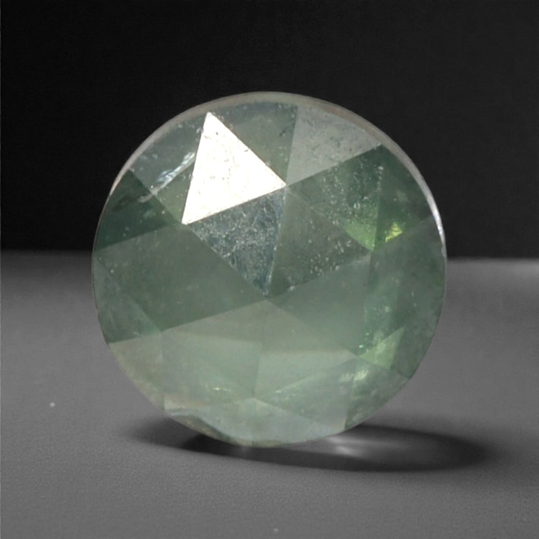 0.26 Carats Fancy Green Rose Cut Diamond - Natural Loose Gemstone, 48DA: This 0.26 carat rose cut diamond captivates with a soft, luminous fancy green hue that radiates gentle vibrancy from its distinctive flat, faceted surface. The classic rose cut, with its symmetrical a