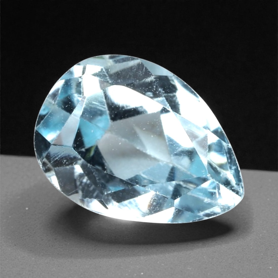 4.44 Carats Sky Blue Topaz Pear - Natural Brazilian Stone, 359A: This luminous sky blue topaz gem captivates with a soft, icy blue hue that evokes the clarity of a bright winter sky and the tranquility of glacial waters. Cut in a well-proportioned pear shape, the s