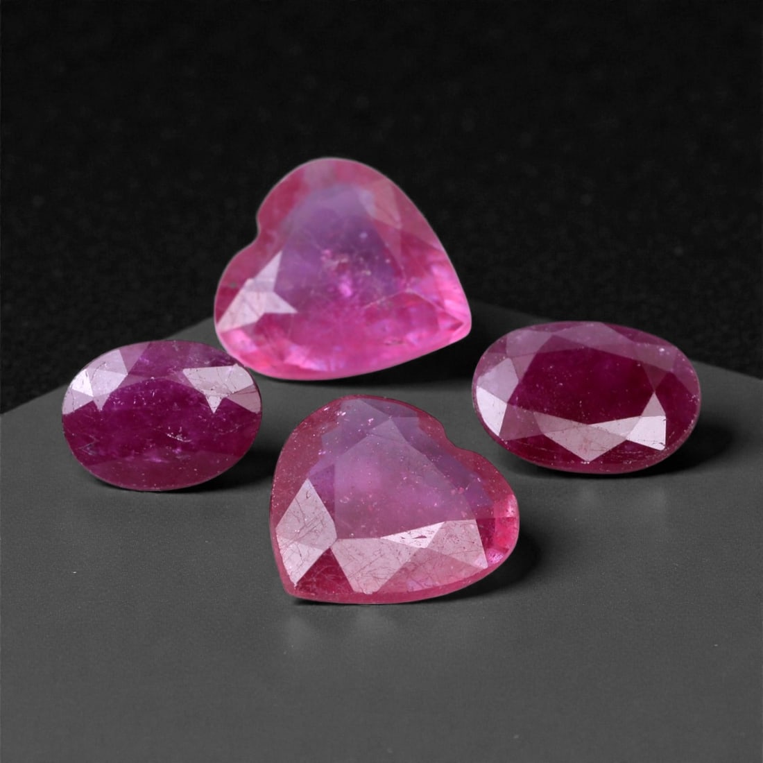7.52 Carats Rosy Red Ruby Selection - Natural Mozambique Stones, 6-8mm, 70XH: This vivid selection of rubies glows with an inviting rosy red tone, ranging from rich berry hues to lively pink-red flashes under light. The group includes both oval and heart shapes, each faceted to