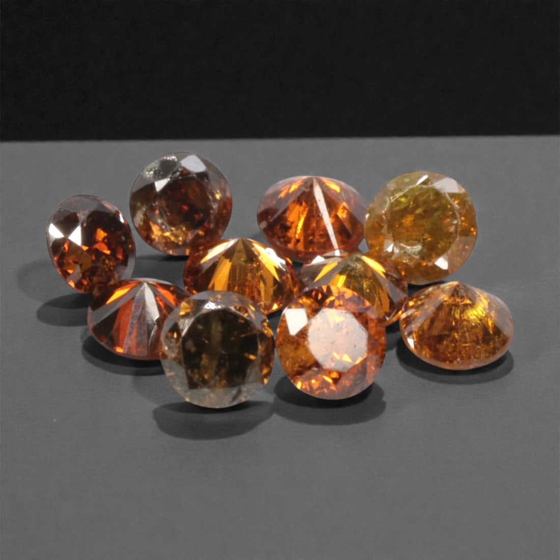 10 Pieces Irradiated Red Diamond Parcel - Round Brilliant Cut, 1.6-1.7mm, 265A: This vibrant parcel of 10 loose irradiated red diamond gems captivates with a rich, fiery red hue that evokes the intensity of a glowing ember and the warmth of a sunset. Each stone is cut in a well-p