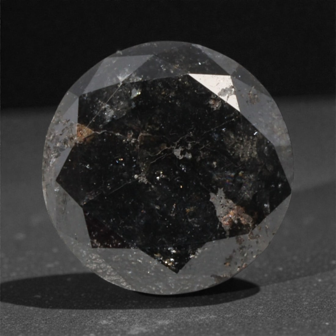 1.74 Carats Black Diamond - Round Brilliant Cut, 283A: This substantial black diamond captivates with a deep, opaque black hue that evokes the intensity of polished obsidian and the mystery of a midnight sky. Cut in a well-proportioned round brilliant sha