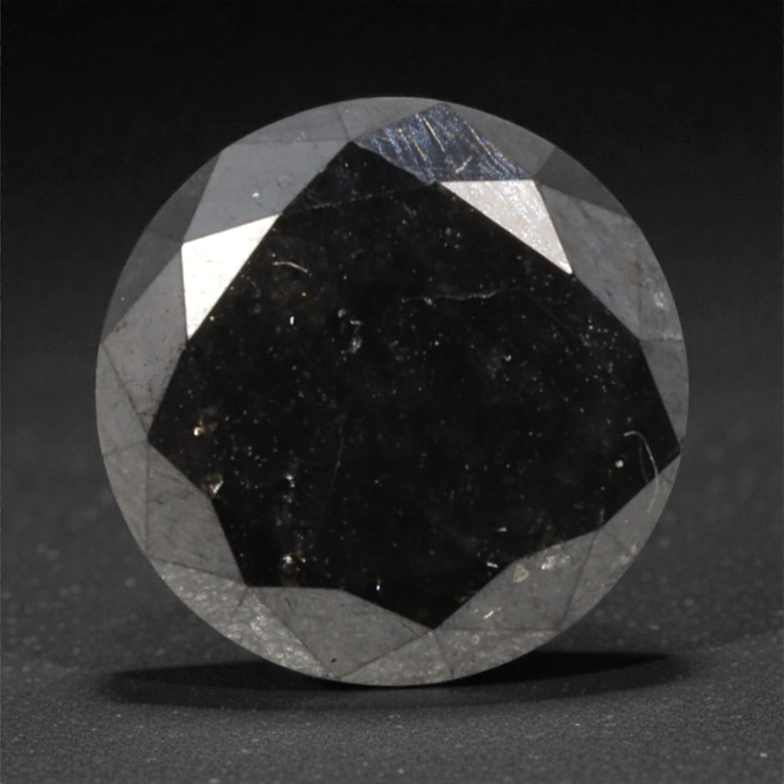 1.97 Carats Black Diamond - Round Brilliant Cut, 288A: This substantial black diamond captivates with a deep, opaque black hue that evokes the intensity of polished obsidian and the mystery of a midnight sky. Cut in a well-proportioned round brilliant sha