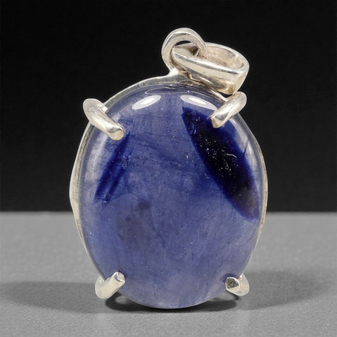 15.64 Carats Deep Blue Sapphire Cabochon Pendant - Sterling Silver Setting, 158A: This striking pendant features a substantial deep blue sapphire cabochon, set in a polished sterling silver frame stamped 925. The cabochon's smooth, domed surface radiates with a rich, velvety blue h