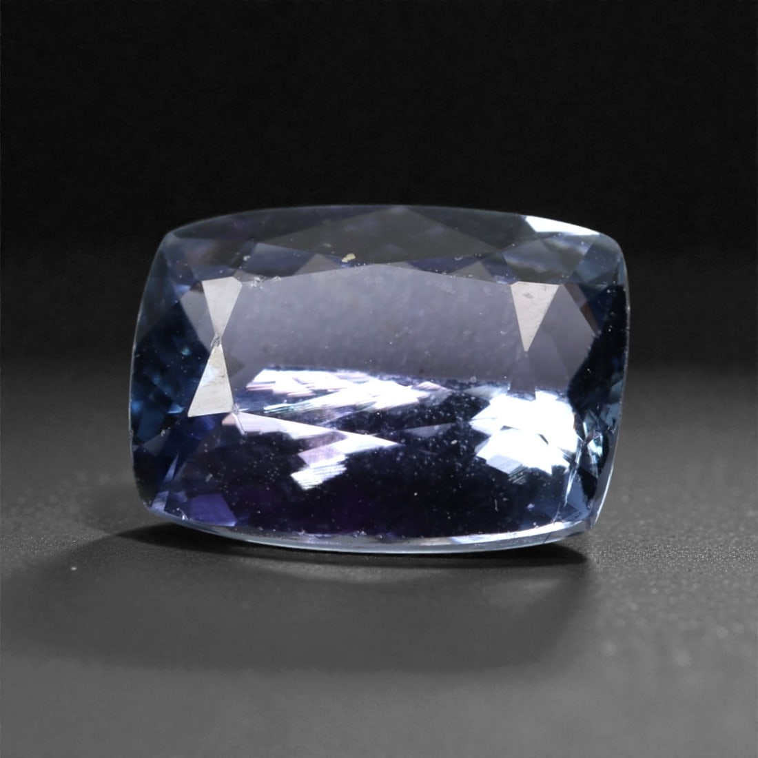 2.48 Carats Violet Blue Tanzanian Tanzanite Cushion Cut - 9.4 x 7.1 x 4.2 mm, 54XK: This striking tanzanite presents a richer violet blue tone with flashes of indigo and soft lavender under changing light. The cushion cut delivers broad, mirror-like reflections across the crown, givi