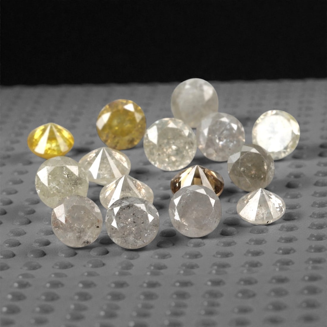 1.04 Carats Fancy Yellow Diamond Parcel - Natural African Stones, 54A: This exquisite parcel of round fancy diamonds radiates with a warm, honeyed glow, ranging from soft lemon and buttercup hues to deeper golden amber tones. Each stone is precision-cut to maximize light