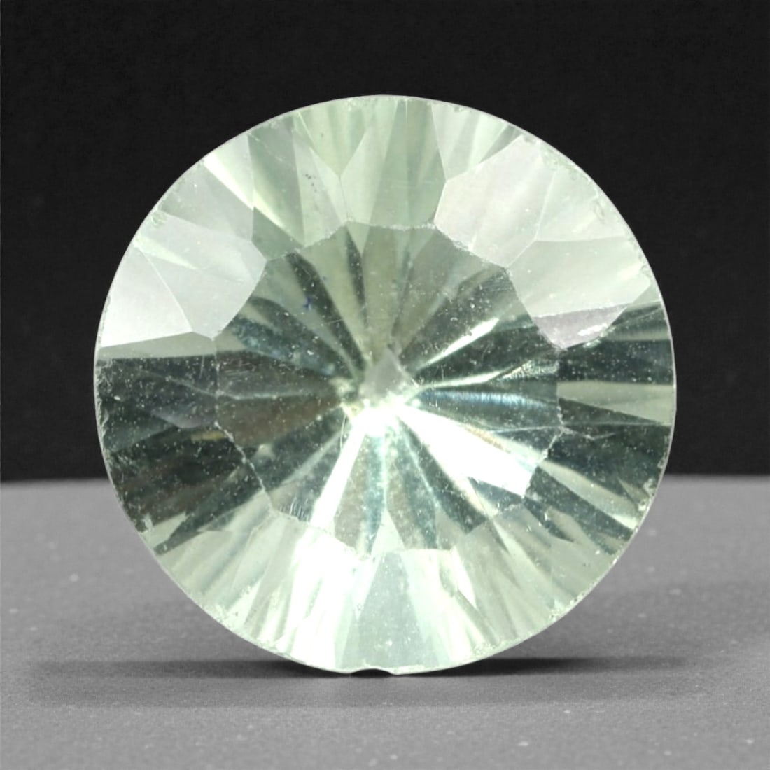 3.13 Carats Pale Green Fluorite Round - Natural Mexican Stone, 343A: This luminous pale green fluorite gem captivates with a soft, milky green hue that evokes the tranquility of frosted glass and the gentle glow of moonlight. Cut in a well-proportioned round brilliant