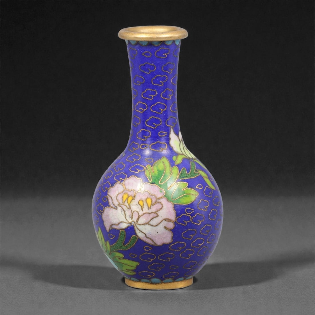 A Chinese Cloisonne Enamel Vase, 20th Century, 82YC: Constructed from a copper alloy body and decorated with cloisonne enamel, the vessel is of baluster form with a rounded body rising to a tall, slightly flared neck and a gilt metal rim. The surface is
