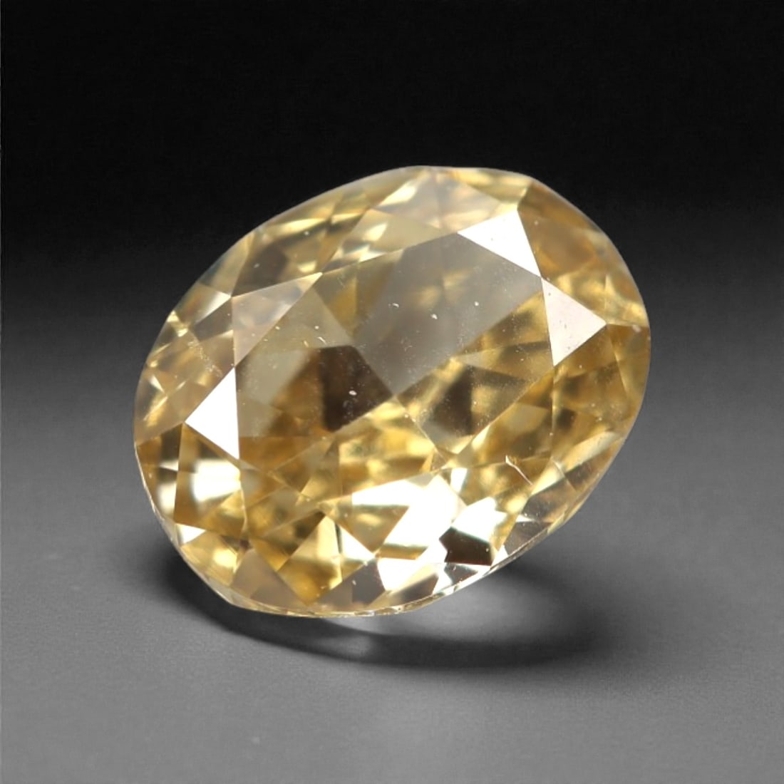 0.38 Carats Fancy Light Yellow Diamond - Natural South African Origin, 10DA: This 0.38 carat fancy light yellow diamond glows with a soft, buttery hue reminiscent of sun-warmed honey, its oval brilliant cut amplifying a luminous, lively sparkle across every precisely polished