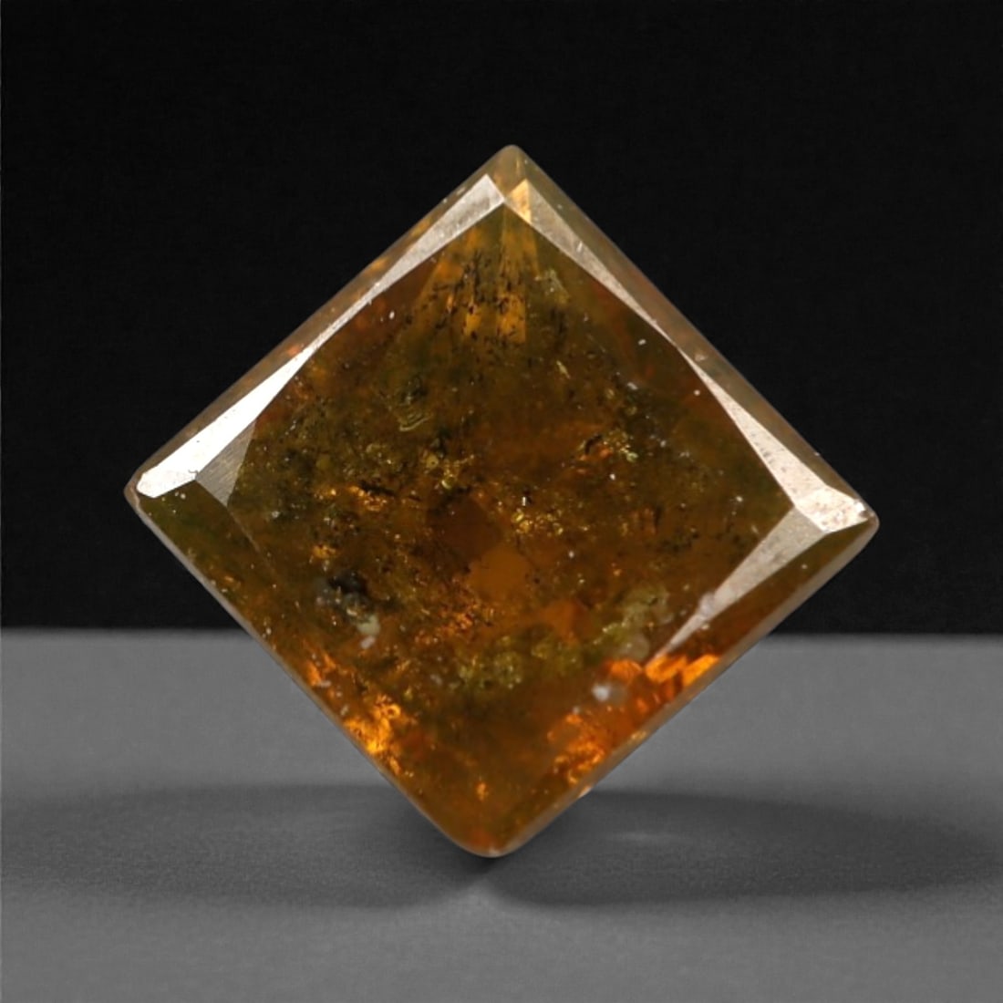 0.28 Carats Orangy Red Fancy Diamond - Princess Cut, 186A: This rare fancy orangy red diamond captivates with a vivid, warm hue that evokes the intensity of a glowing ember and the richness of a sunset. Cut in a well-proportioned princess shape, the stone's f